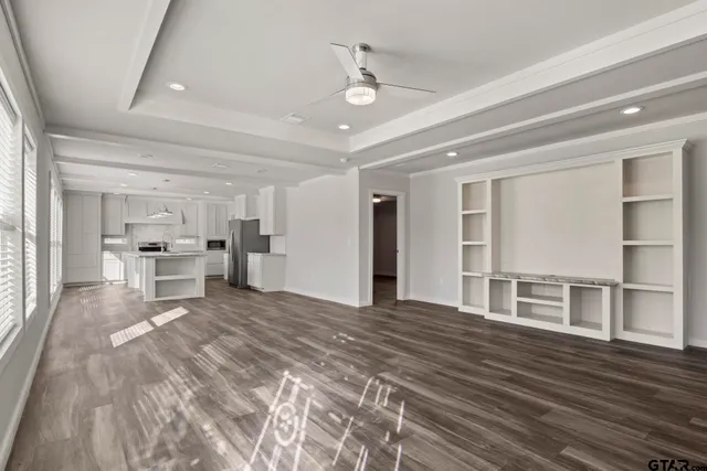 a view of a bedroom with furniture and window