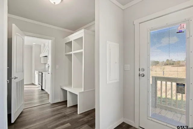 a view of a hallway with wooden floor and glass door