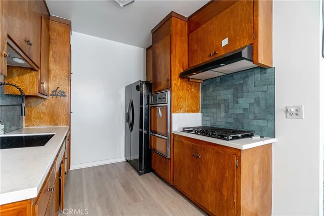 a kitchen with wooden cabinets and a stove top oven