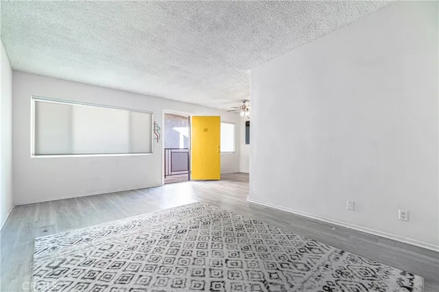 an empty room with a window and fireplace