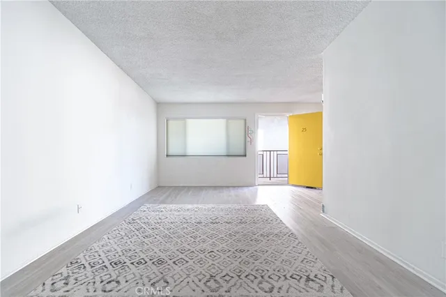 a view of a kitchen cabinets a sink and wooden floor