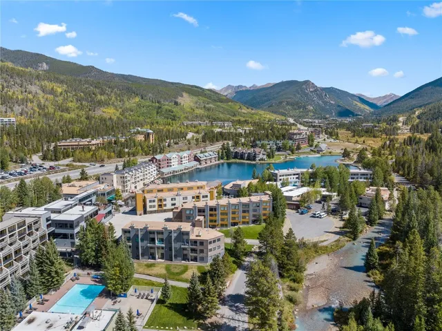 a view of swimming pool with outdoor seating and mountain view in back