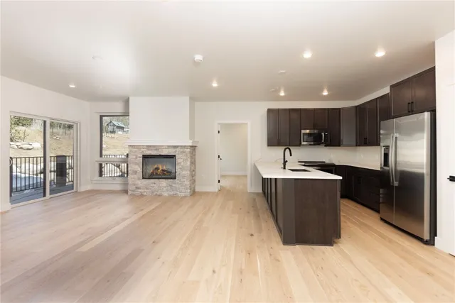 a kitchen with kitchen island stainless steel appliances and sink