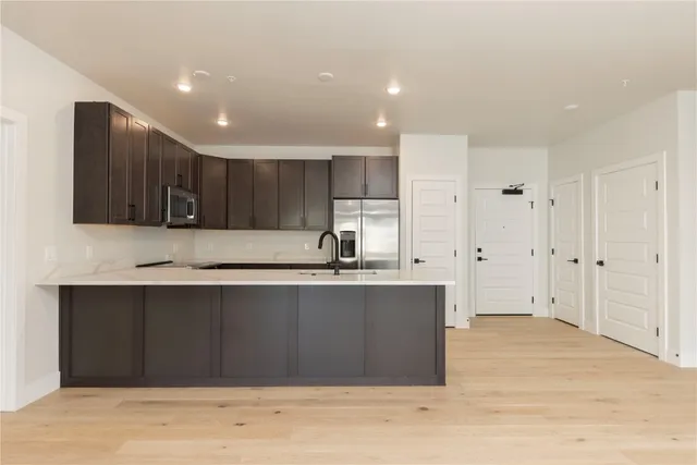 a bathroom with a bathtub shower sink vanity and toilet