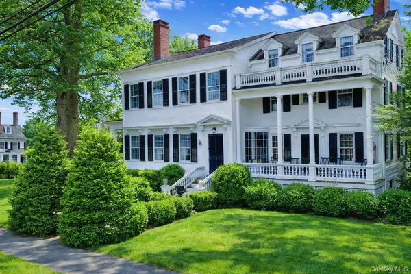 a view of a house with a yard and potted plants
