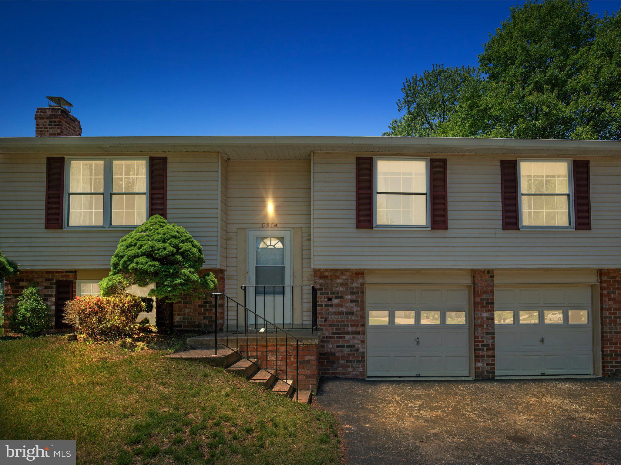 6314 West Vein Road Bowie, MD 20720 - Photo 2 of 28 a view of a brick house with a yard