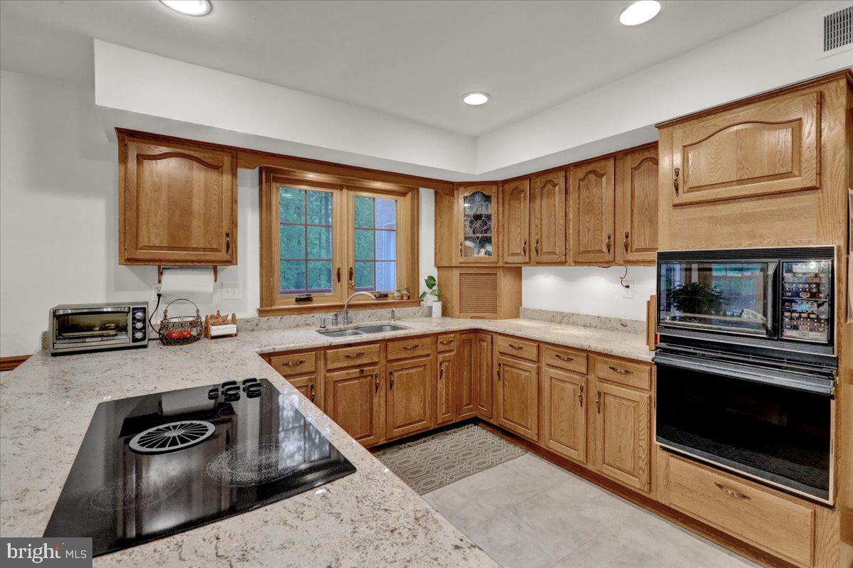 586 Berwyn Baptist Road Devon, PA 19333 - Photo 25 of 49 a kitchen with a stove a sink and a microwave