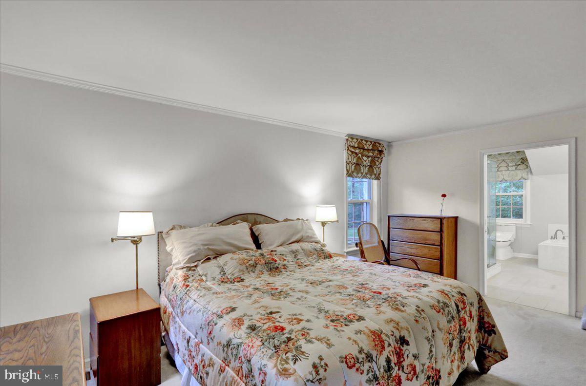 586 Berwyn Baptist Road Devon, PA 19333 - Photo 35 of 49 a bedroom with a bed and dresser with mirror