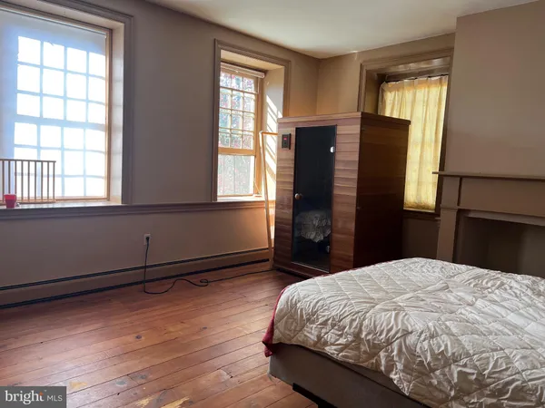 a bedroom with a bed dresser and a window