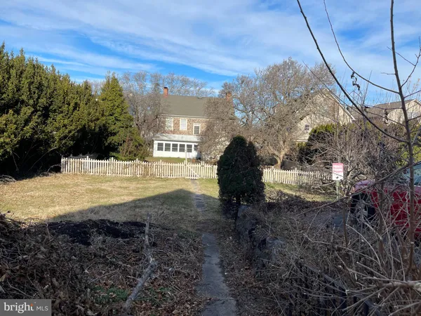 a view of a yard with wooden fence
