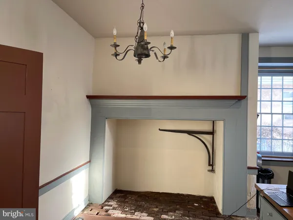 a view of room with stairs and chandelier