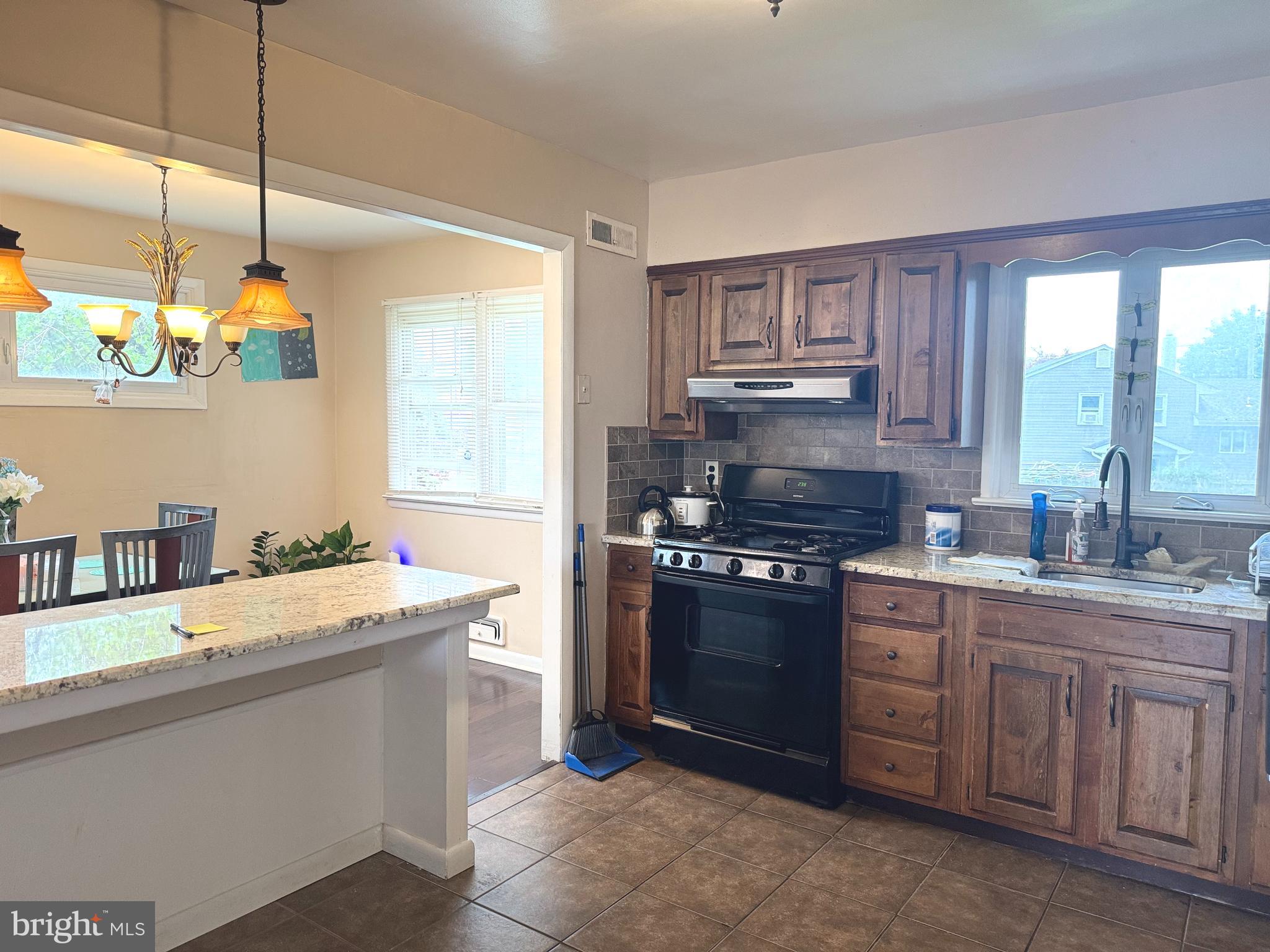 100 Winding Way Hamilton, NJ 08620 - Photo 5 of 9 a kitchen with a sink stove top oven and cabinets