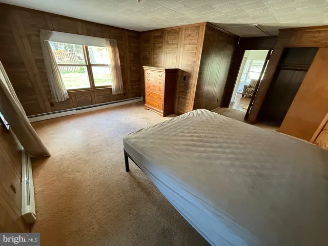 a bedroom with a large bed and a large window