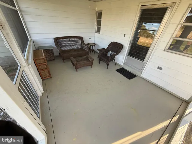 a view of an chairs and table in a balcony