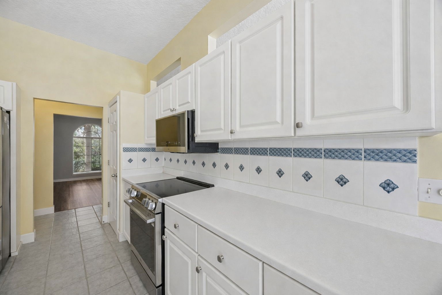 95406 Captains Way Fernandina Beach, FL 32034 - Photo 12 of 51 Thoughtful architectural openings above the cabinetry keep the kitchen feeling open rather than enclosed.