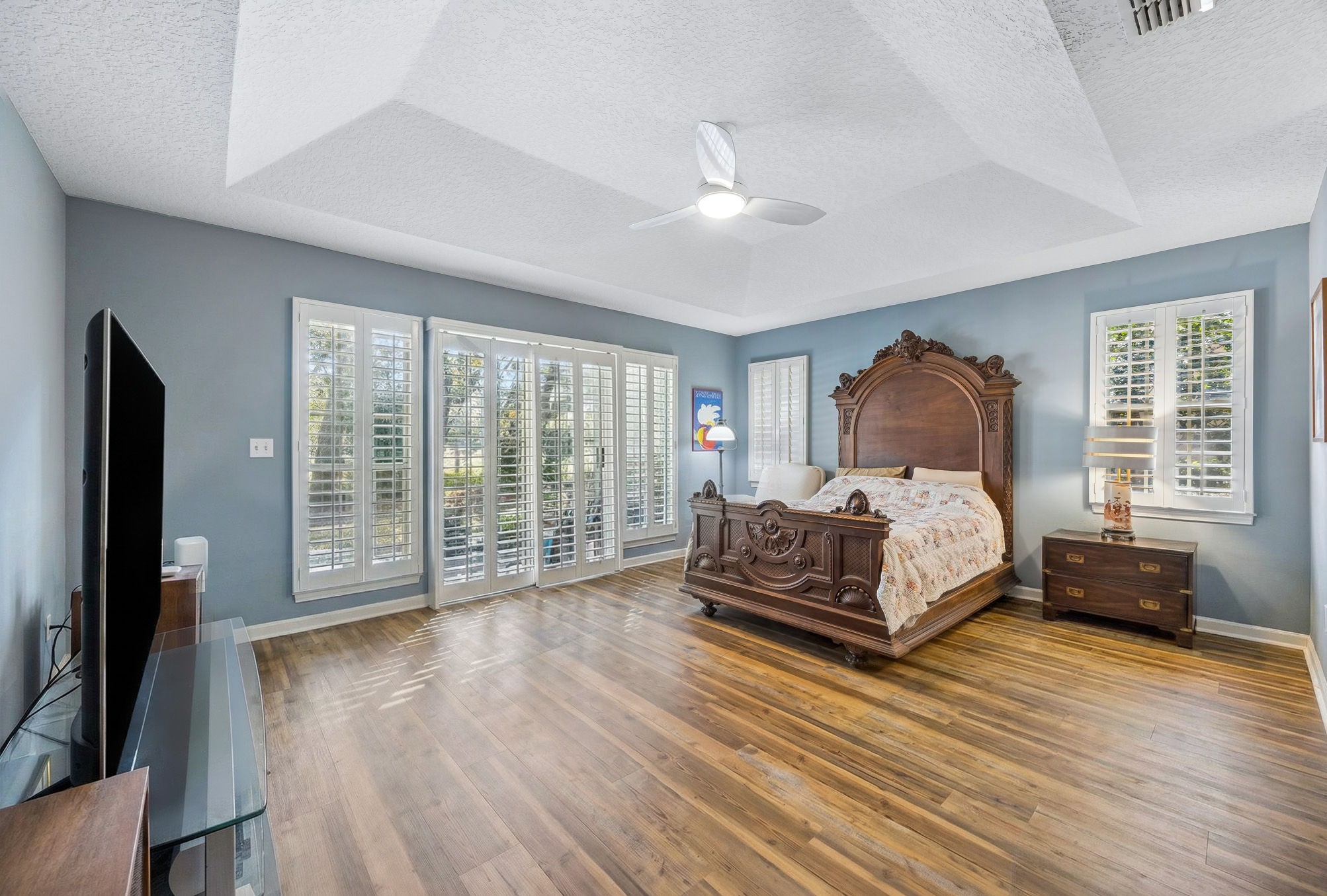95406 Captains Way Fernandina Beach, FL 32034 - Photo 16 of 51 The primary suite is generously scaled, with a tray ceiling, plantation shutters, and a calm, tucked-away feel.