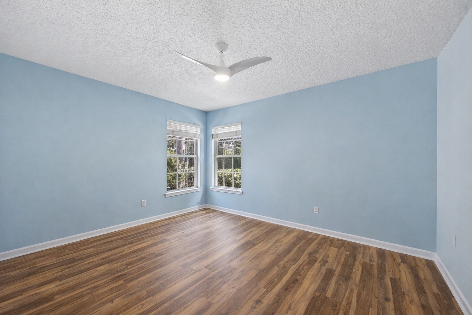 95406 Captains Way Fernandina Beach, FL 32034 - Photo 22 of 51 An additional bedroom offers flexibility for guests, hobbies, or work-from-home needs, while tall ceilings, abundant glass, and Minka ceiling fans enhance the home’s open, comfortable feel.