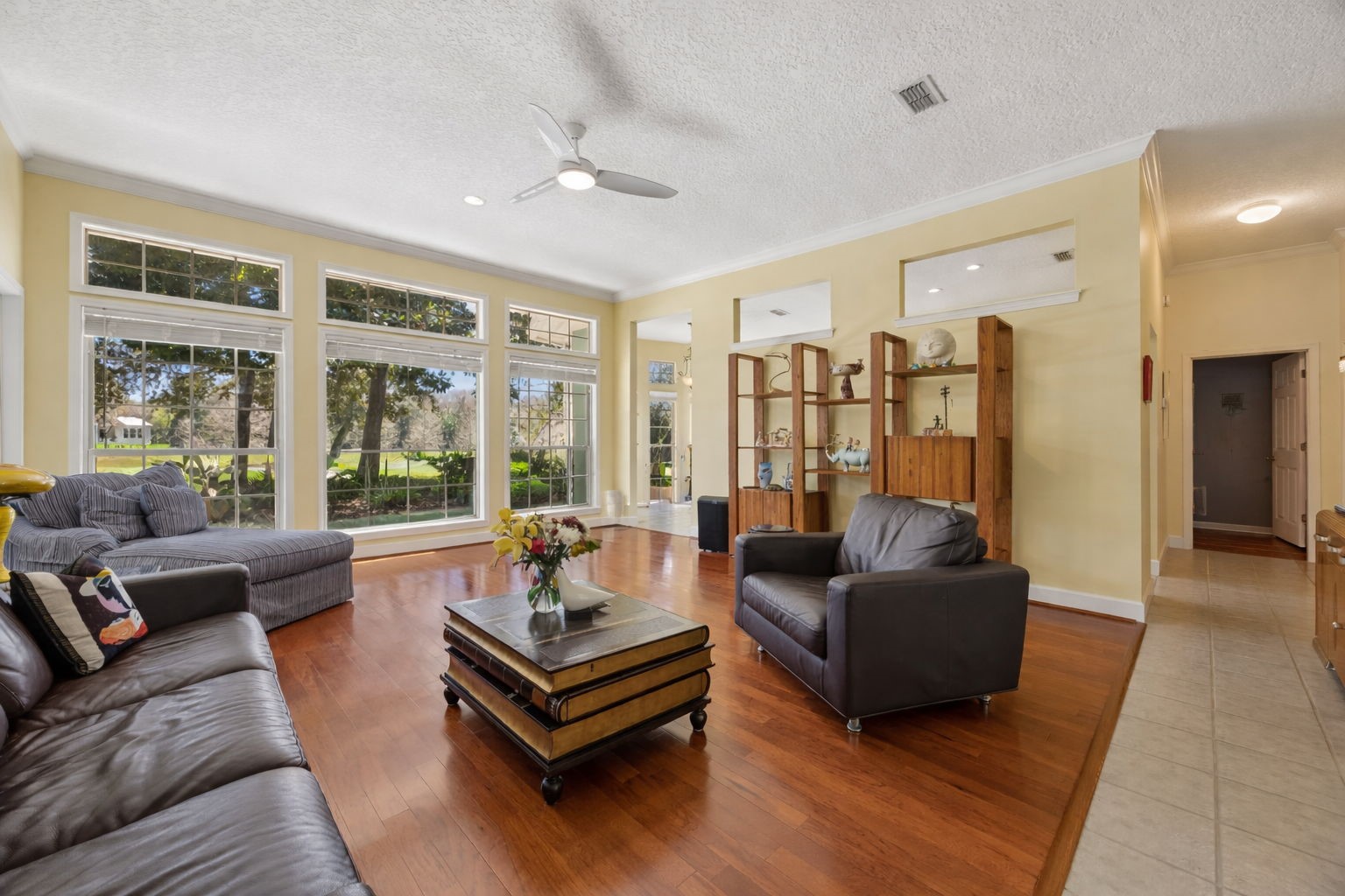 95406 Captains Way Fernandina Beach, FL 32034 - Photo 10 of 51 From the foyer, the home opens into a spacious main living area where wraparound windows, abundant natural light, and Karndean Van Gogh luxury vinyl plank floors bring warmth and a bright, welcoming feel.