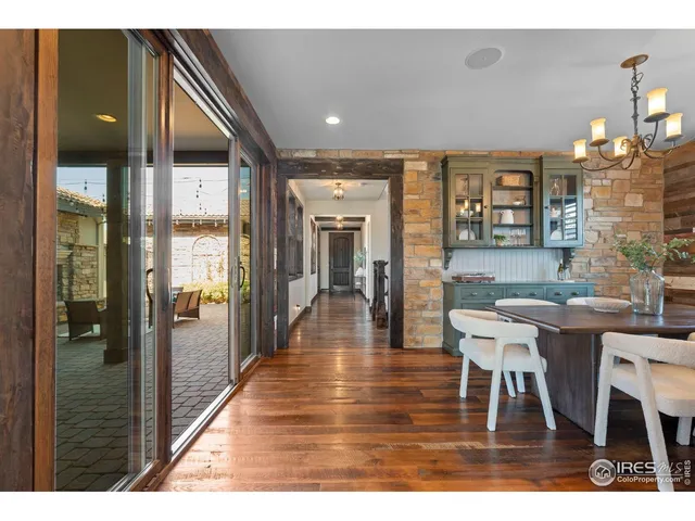 a dining room with furniture a chandelier and wooden floor