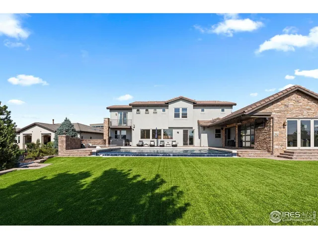 a view of swimming pool with a table and chairs
