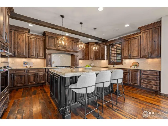 a kitchen with a wooden table and chairs