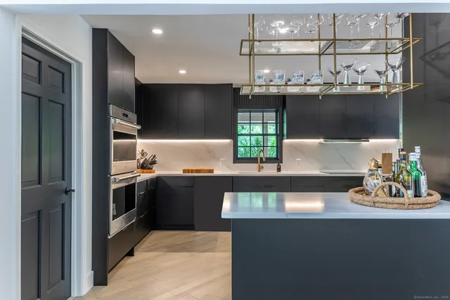 a view of washer and dryer with bathroom in the background