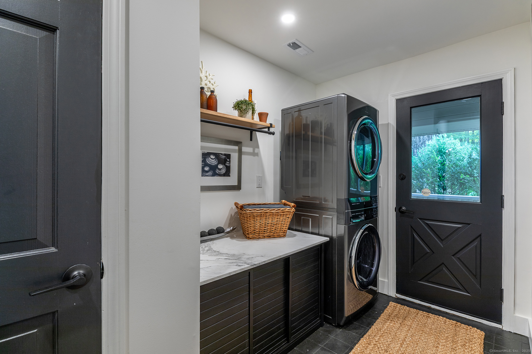 15 Herrick Road Sharon, CT 06069 - Photo 15 of 39 a view of washer and dryer with bathroom in the background