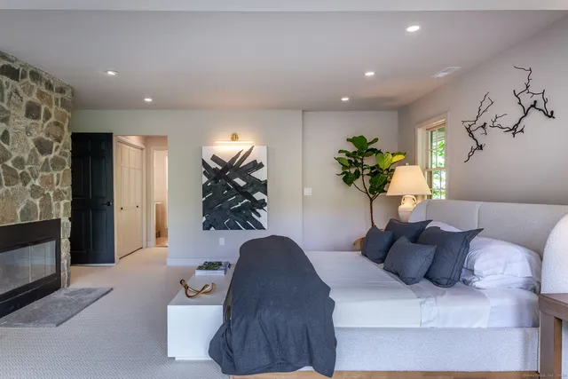 a living room with furniture and floor to ceiling window