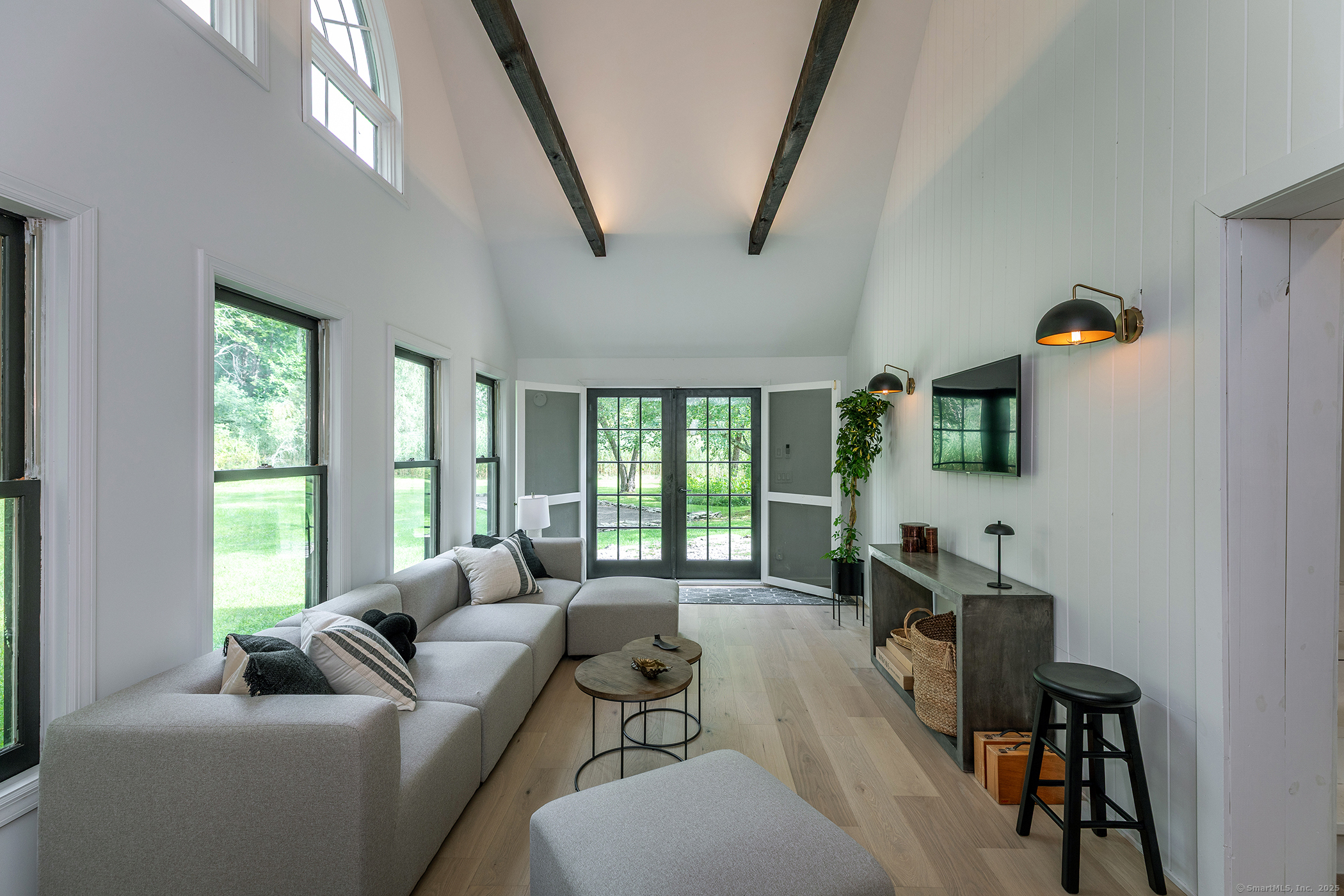 15 Herrick Road Sharon, CT 06069 - Photo 29 of 39 a living room with furniture a flat screen tv and a large window