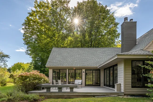 a dining room with furniture a chandelier and window