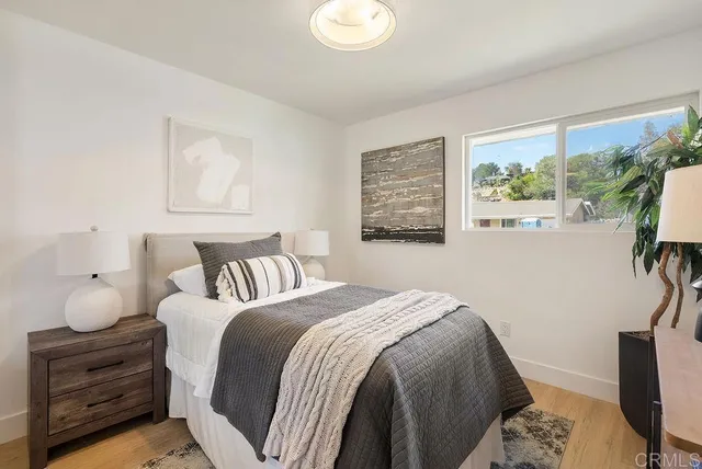 a bedroom with a bed and a window