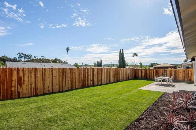 a view of a backyard with sitting area