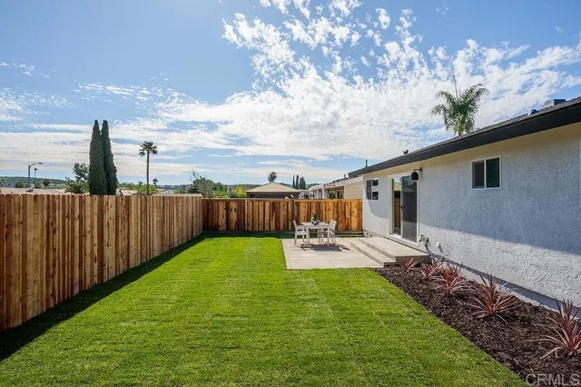 a view of a backyard with sitting area