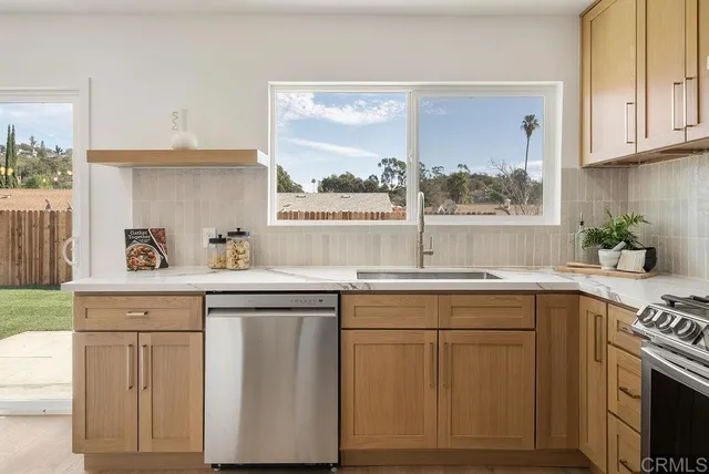 a kitchen with white cabinets and a stove