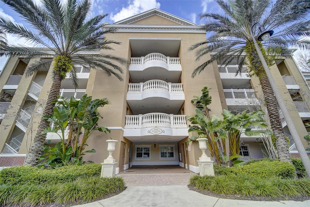 7651 Whisper Way, Unit 104 Reunion, FL 34747 - Photo 1 of 1 a front view of a house with a garden