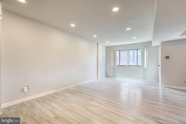 a view of wooden floor and windows in a room