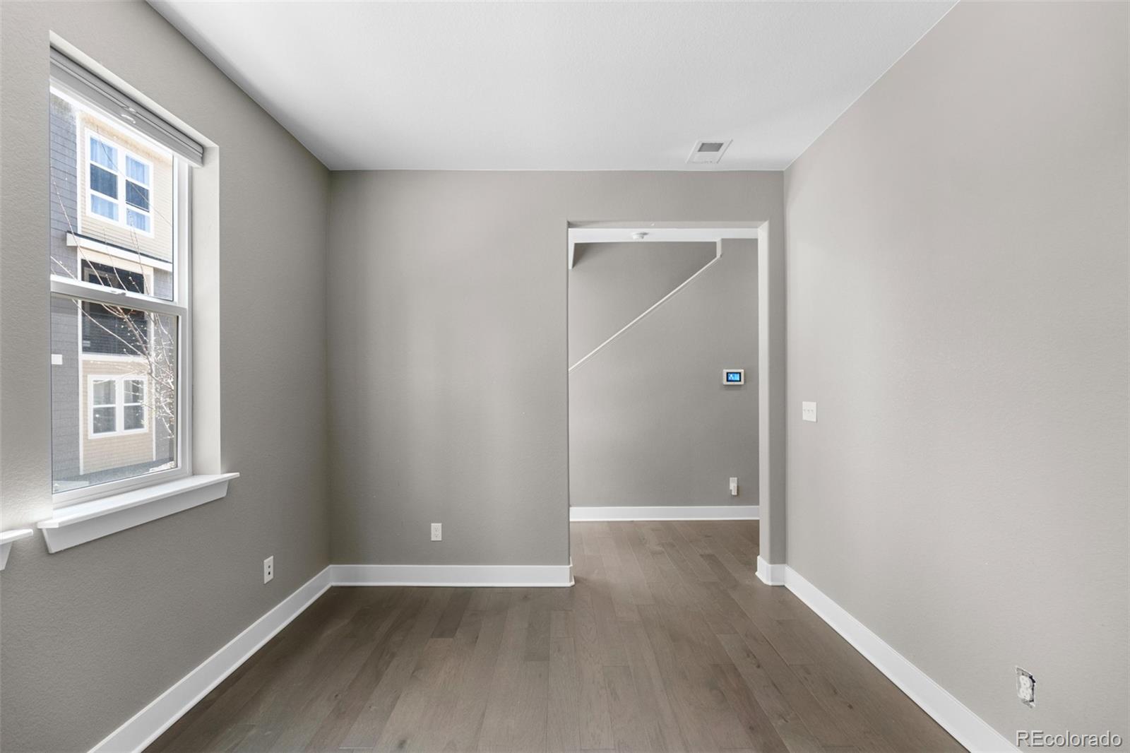 11918 Mountview Lane Broomfield, CO 80021 - Photo 13 of 32 a view of an empty room with wooden floor and a window