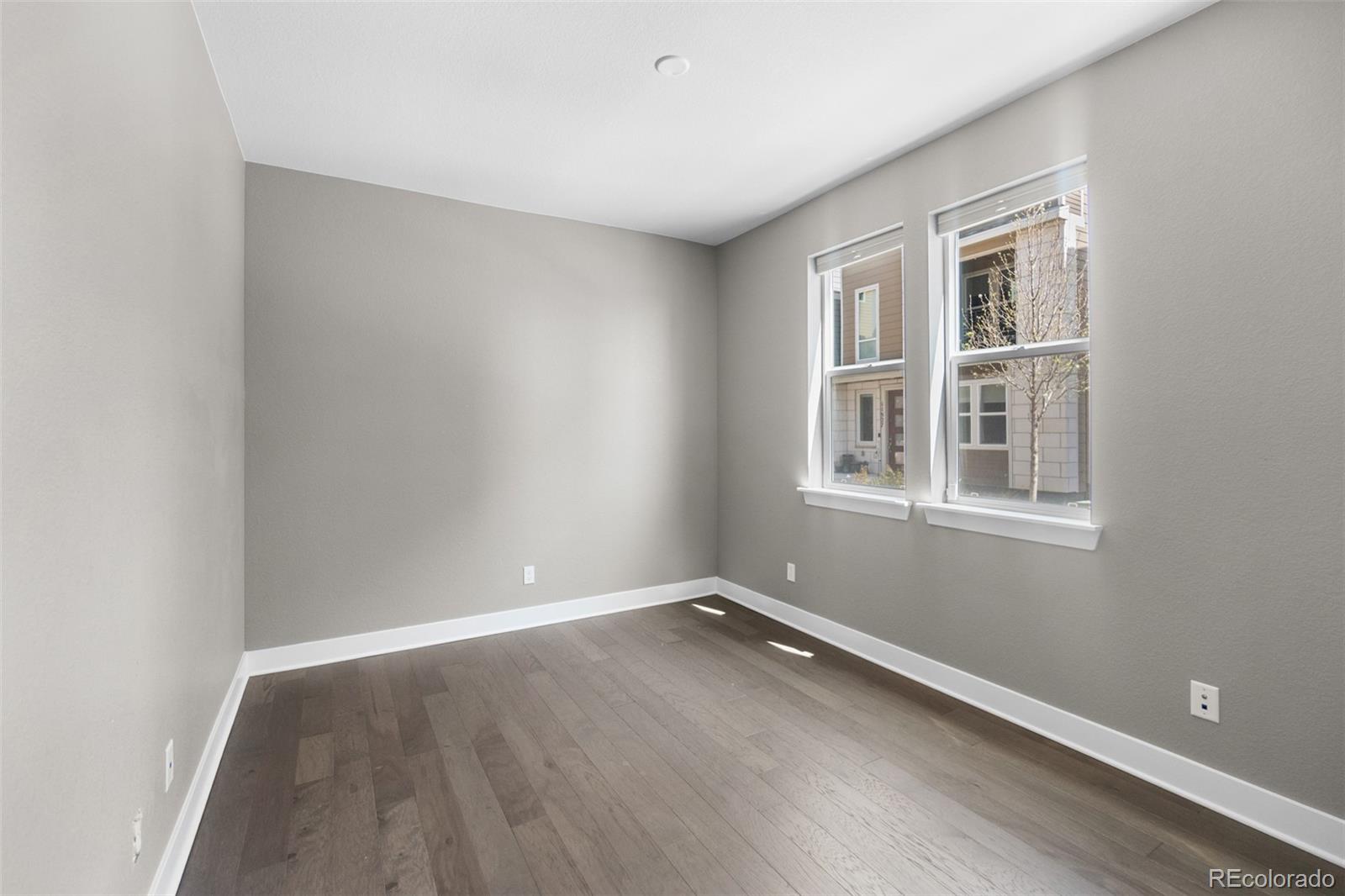 11918 Mountview Lane Broomfield, CO 80021 - Photo 15 of 32 a view of a room with wooden floor and windows