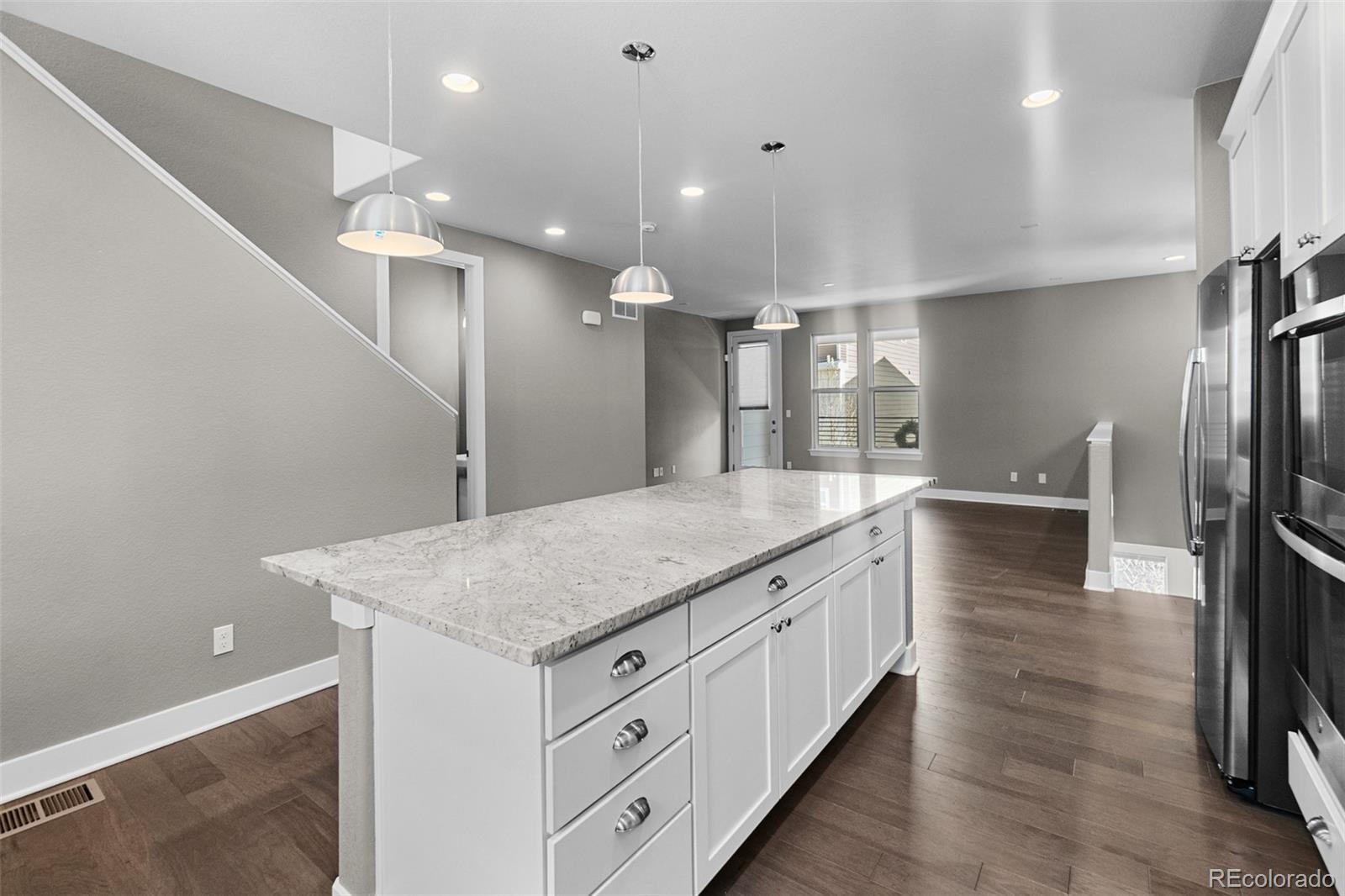 11918 Mountview Lane Broomfield, CO 80021 - Photo 7 of 32 a bathroom with a granite countertop sink a toilet and a large mirror