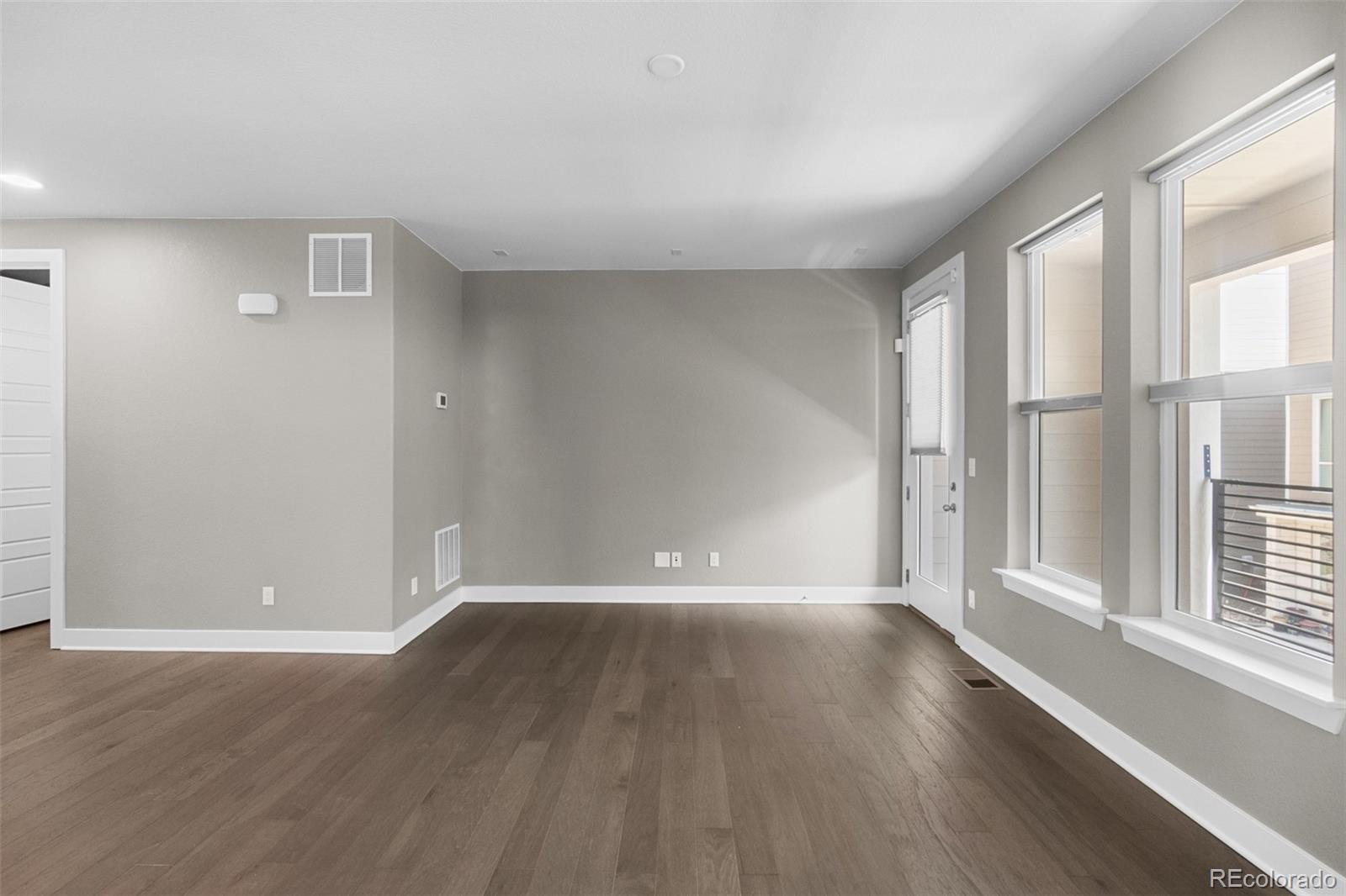 11918 Mountview Lane Broomfield, CO 80021 - Photo 9 of 32 wooden floor in an empty room with a window