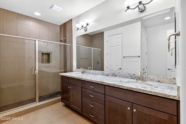 a bathroom with a granite countertop sink and mirror