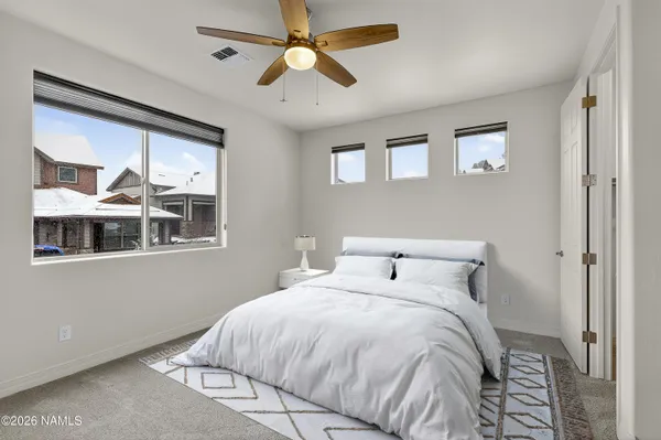 a bedroom with a large bed and a window