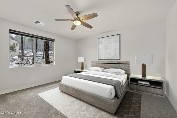 a bedroom with a large bed and a window