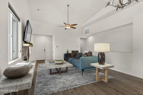 a living room with furniture and a wooden floor
