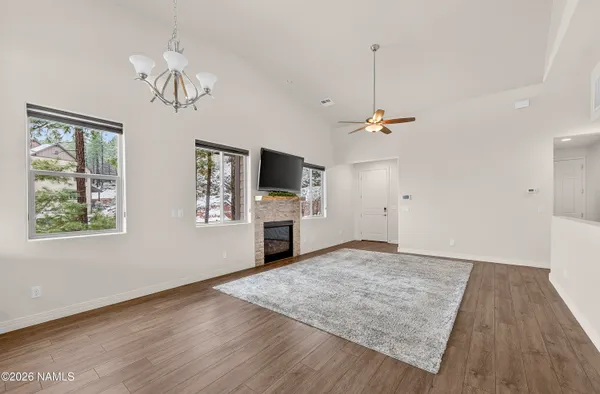 a view of a livingroom with a flat screen tv a ceiling fan and window
