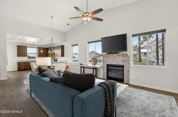 a living room with furniture a fireplace and a flat screen tv