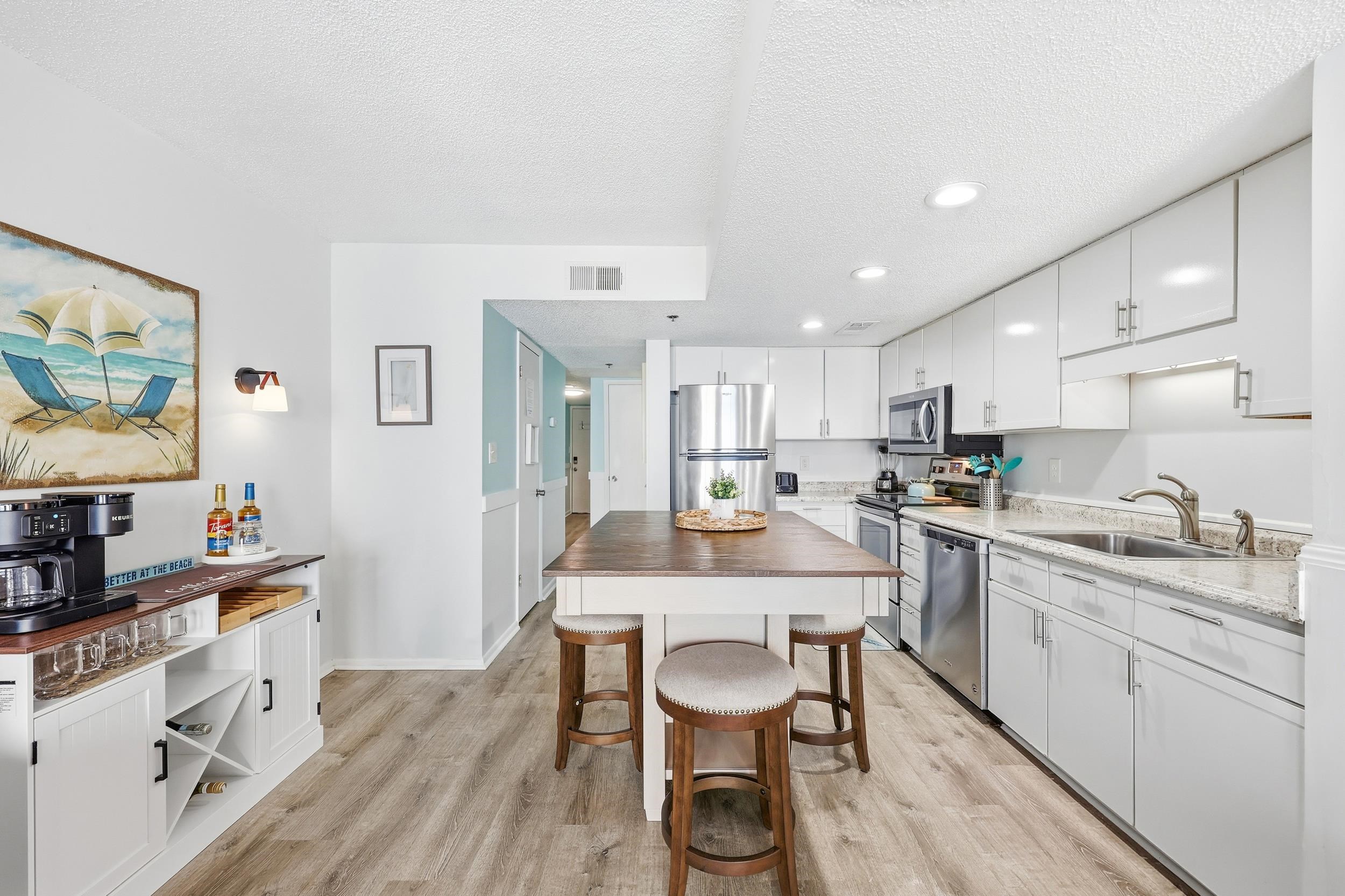 920 North Waccamaw Drive, Unit 2305 Murrells Inlet, SC 29576 - Photo 11 of 40 Kitchen featuring white cabinetry, appliances with stainless steel finishes, a textured ceiling, recessed lighting, and light wood-style flooring