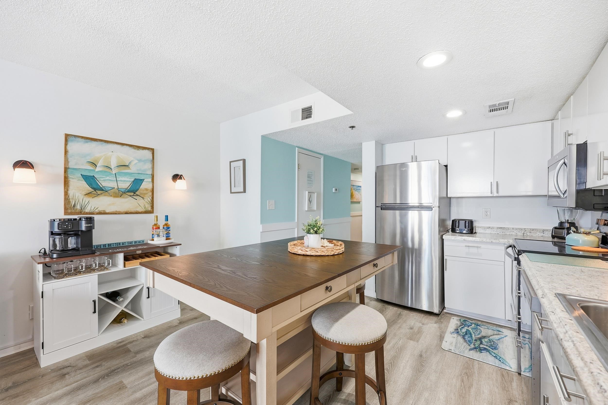 920 North Waccamaw Drive, Unit 2305 Murrells Inlet, SC 29576 - Photo 12 of 40 Kitchen featuring stainless steel appliances, white cabinets, a textured ceiling, light wood-type flooring, and wooden counters