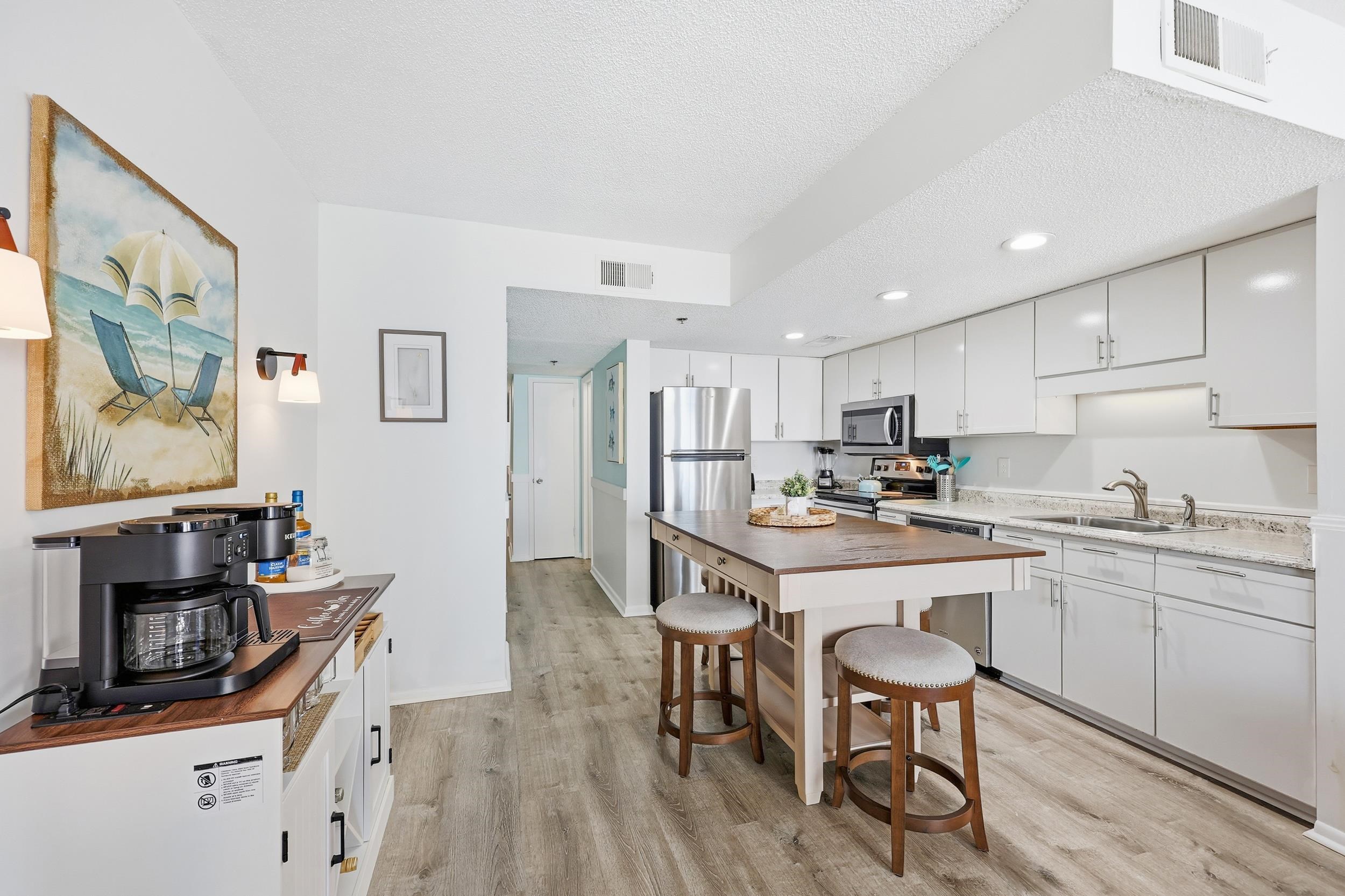 920 North Waccamaw Drive, Unit 2305 Murrells Inlet, SC 29576 - Photo 13 of 40 Kitchen featuring white cabinetry, light wood-style flooring, appliances with stainless steel finishes, recessed lighting, and a breakfast bar area