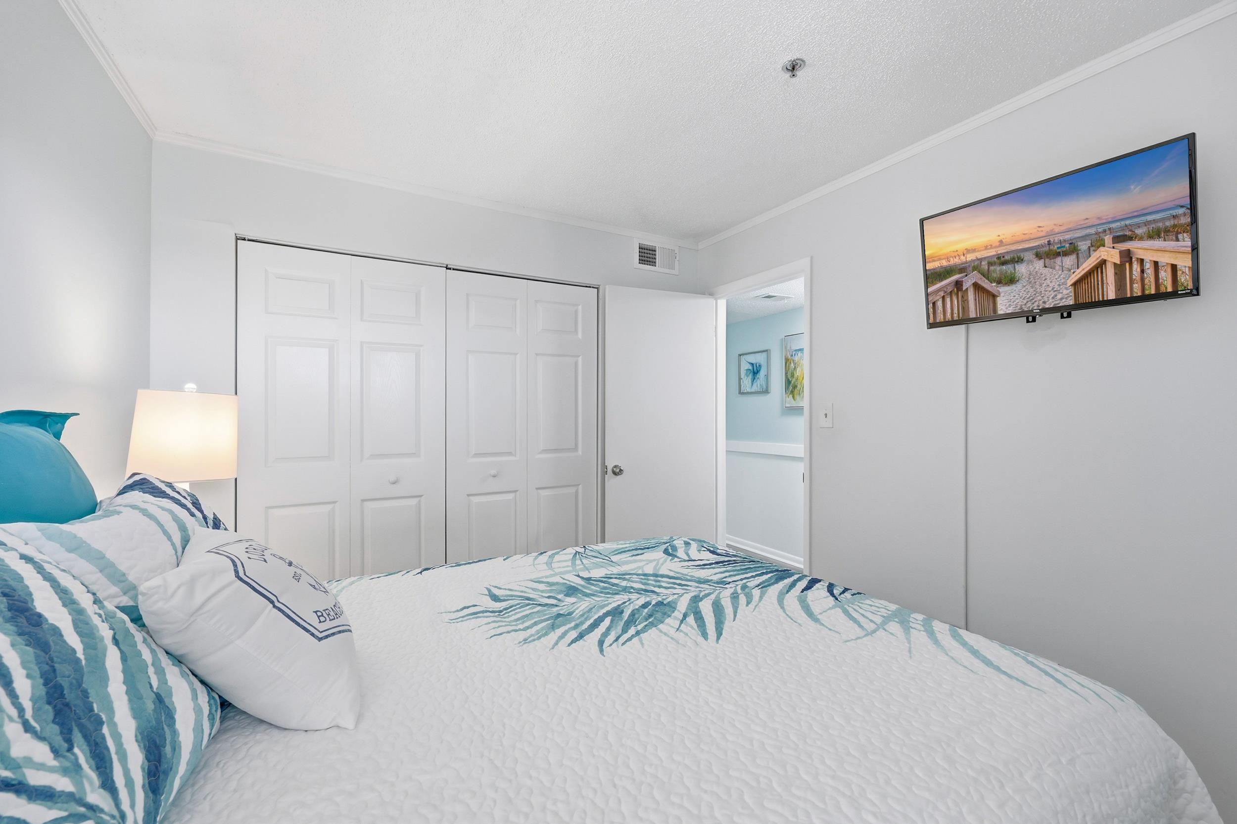 920 North Waccamaw Drive, Unit 2305 Murrells Inlet, SC 29576 - Photo 4 of 40 Bedroom with crown molding, a closet, and a textured ceiling